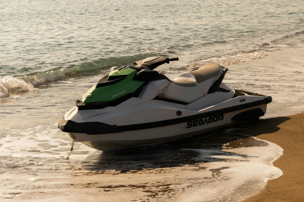 Personal watercraft beached at the shoreline by small waves