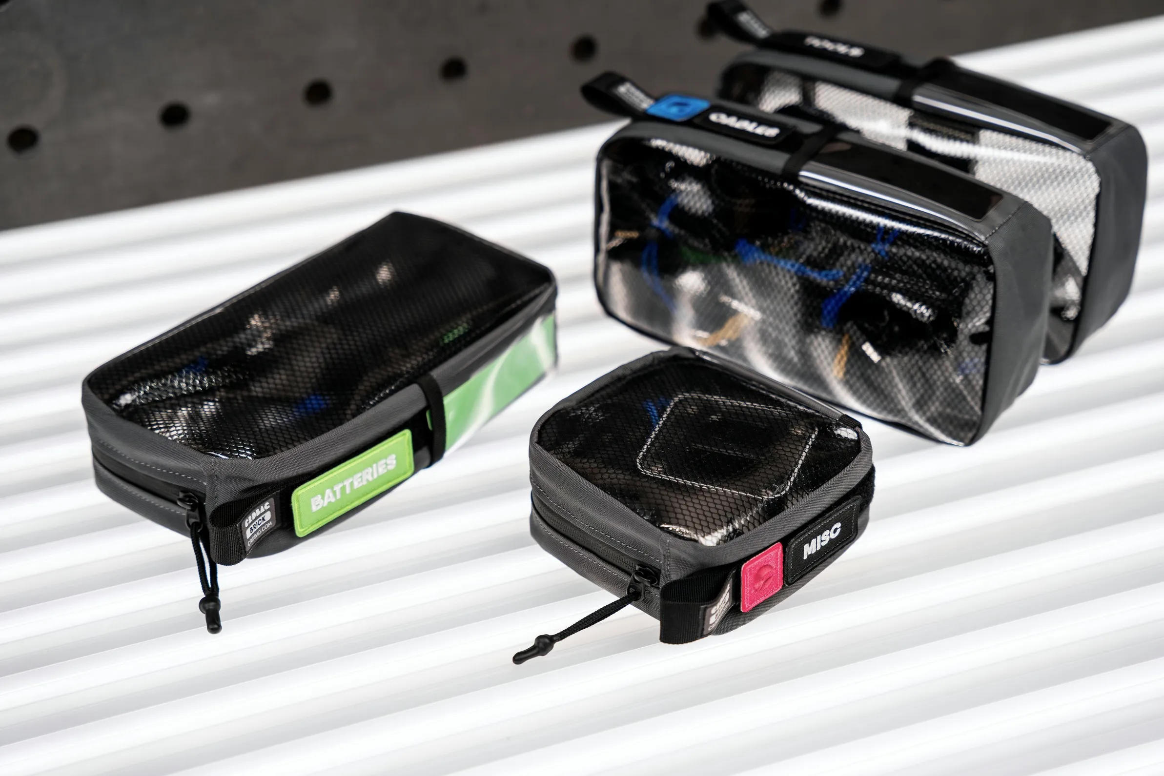 Small waterproof storage pouches for batteries, cables, and other gear on a boat